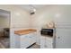 Additional kitchen space with counter, cabinets, microwave and charming nautical accents at 200 Portree Dr, Dunedin, FL 34698