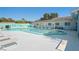 Large swimming pool with plenty of deck space for lounge chairs and outdoor seating by the community clubhouse at 200 Portree Dr, Dunedin, FL 34698