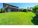 Spacious backyard with screened pool area, landscaping and well-maintained lawn at 21794 Pristine Lake Blvd, Land O Lakes, FL 34637