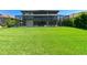 Expansive backyard with a screened pool and lush green lawn, ideal for recreation at 21794 Pristine Lake Blvd, Land O Lakes, FL 34637
