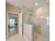 Walk-in shower featuring tiled walls and floors, glass door, and a rainfall showerhead at 21794 Pristine Lake Blvd, Land O Lakes, FL 34637