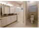 Bathroom with a glass shower door, double vanity, granite countertops, and natural lighting at 21794 Pristine Lake Blvd, Land O Lakes, FL 34637