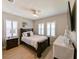 Cozy bedroom with a ceiling fan, shuttered windows, and a comfortable bed at 21794 Pristine Lake Blvd, Land O Lakes, FL 34637