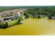 Aerial view of the community featuring the lake, a boat ramp and many homes with private dock access at 21794 Pristine Lake Blvd, Land O Lakes, FL 34637