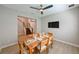 An inviting dining room features a table set for six, a ceiling fan, and views of the staircase at 21794 Pristine Lake Blvd, Land O Lakes, FL 34637