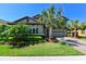 Beautiful two-story home featuring a well-manicured lawn, lush landscaping, and a paver driveway leading to the two-car garage at 21794 Pristine Lake Blvd, Land O Lakes, FL 34637