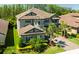 Beautiful home with a tile roof, lush landscaping, and a paver driveway leading to a two-car garage at 21794 Pristine Lake Blvd, Land O Lakes, FL 34637