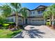 Charming two-story home with a three-car garage, beautiful landscaping, and a paved driveway at 21794 Pristine Lake Blvd, Land O Lakes, FL 34637