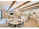 Open kitchen and dining area with a spacious island, stainless steel appliances, and exposed beams at 21794 Pristine Lake Blvd, Land O Lakes, FL 34637