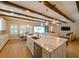 Bright kitchen boasts large island with quartz countertop, stainless steel appliances and exposed beam ceiling at 21794 Pristine Lake Blvd, Land O Lakes, FL 34637