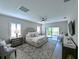 A luxurious main bedroom features plush bedding, a ceiling fan, and a private balcony at 21794 Pristine Lake Blvd, Land O Lakes, FL 34637