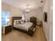 A well lit main bedroom features modern furniture, decorative chandelier, and light colored wood flooring at 21794 Pristine Lake Blvd, Land O Lakes, FL 34637
