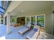 Spacious covered patio with lounge chairs, comfortable seating, and easy access to the pool at 21794 Pristine Lake Blvd, Land O Lakes, FL 34637