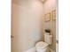 Powder room featuring framed floral art, a toilet, and a plant for added aesthetic at 21794 Pristine Lake Blvd, Land O Lakes, FL 34637