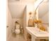 This half bath features gold fixtures, a tiled floor, and a decorative gold mirror at 21794 Pristine Lake Blvd, Land O Lakes, FL 34637