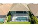 Aerial view of screened-in pool and spa with a spacious, green backyard and view of the home's rear exterior at 21794 Pristine Lake Blvd, Land O Lakes, FL 34637
