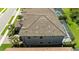 Aerial view of the home's rear exterior featuring a tile roof and view of the rear lanai and backyard at 21794 Pristine Lake Blvd, Land O Lakes, FL 34637