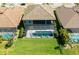 Aerial view of screened-in pool and spa with a spacious, green backyard and view of the home's rear exterior at 21794 Pristine Lake Blvd, Land O Lakes, FL 34637