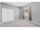 Well-lit bedroom featuring neutral gray walls, ceiling fan, and closet at 27054 Fordham Dr, Wesley Chapel, FL 33543