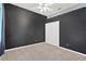 Bedroom with dark walls, ceiling fan, carpeted floor, and closet at 27054 Fordham Dr, Wesley Chapel, FL 33543