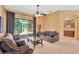 Comfortable living room with neutral tones, a ceiling fan, and sliding doors leading to the outdoors at 27054 Fordham Dr, Wesley Chapel, FL 33543