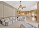 Open living room with neutral tones and a view of the kitchen and dining area at 27054 Fordham Dr, Wesley Chapel, FL 33543