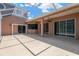 Covered outdoor patio offering lots of space, a ceiling fan, and sliding door access to the home at 27054 Fordham Dr, Wesley Chapel, FL 33543