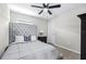 This bedroom features a tufted headboard, carpet, and a ceiling fan with a light fixture at 31966 Asbury Ave, Wesley Chapel, FL 33545
