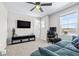 Cozy bedroom with comfortable seating, a workspace, and a large window at 31966 Asbury Ave, Wesley Chapel, FL 33545