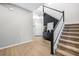 Spacious entryway with stairs, a black accent wall, modern flooring, and stylish décor at 31966 Asbury Ave, Wesley Chapel, FL 33545