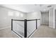 Upstairs hallway featuring decorative railing, and plenty of natural light at 31966 Asbury Ave, Wesley Chapel, FL 33545