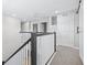 Upstairs hallway featuring decorative railing, and plenty of natural light at 31966 Asbury Ave, Wesley Chapel, FL 33545