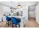 Bright kitchen featuring a modern island with a waterfall quartz countertop and stainless steel appliances at 31966 Asbury Ave, Wesley Chapel, FL 33545