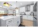 Bright kitchen features a farmhouse sink, stainless steel appliances, and modern white cabinetry at 31966 Asbury Ave, Wesley Chapel, FL 33545