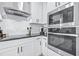 This modern kitchen features stainless steel appliances, white cabinetry, and stylish countertops at 31966 Asbury Ave, Wesley Chapel, FL 33545