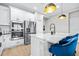 Stylish kitchen boasts stainless steel appliances, a breakfast bar with quartz countertop and modern pendant lighting at 31966 Asbury Ave, Wesley Chapel, FL 33545
