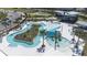 Community's luxurious lazy river and clubhouse, surrounded by palm trees at 31966 Asbury Ave, Wesley Chapel, FL 33545
