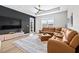 Comfortable living room showcases a large sectional sofa, stylish decor, and plenty of natural light at 31966 Asbury Ave, Wesley Chapel, FL 33545