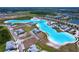 Stunning aerial view of a community lagoon, complemented by attractive homes and a variety of resort-style amenities at 32046 Powderpuff Mimosa Dr, San Antonio, FL 33576
