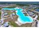 Breathtaking aerial view of a community's lagoon, highlighting waterfront living with modern homes and recreational facilities at 32046 Powderpuff Mimosa Dr, San Antonio, FL 33576