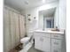 Bright bathroom with modern vanity, mirror, decorative shelves, and tiled floor at 32046 Powderpuff Mimosa Dr, San Antonio, FL 33576