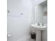 Powder room featuring a pedestal sink, mirror, and modern fixtures at 32046 Powderpuff Mimosa Dr, San Antonio, FL 33576