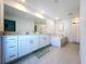 Bright bathroom featuring double vanity, soaking tub and tile floor at 32046 Powderpuff Mimosa Dr, San Antonio, FL 33576