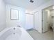 Modern bathroom featuring a soaking tub and glass-enclosed shower at 32046 Powderpuff Mimosa Dr, San Antonio, FL 33576