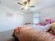 Cozy bedroom featuring a ceiling fan and window with valance at 32046 Powderpuff Mimosa Dr, San Antonio, FL 33576