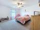 Bedroom featuring a bed, ceiling fan, and window with valance at 32046 Powderpuff Mimosa Dr, San Antonio, FL 33576