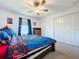 Bedroom featuring a bed, dresser, and ceiling fan at 32046 Powderpuff Mimosa Dr, San Antonio, FL 33576