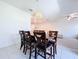 Dining room showcases modern lighting, dining table with seating, and open layout to the living area at 32046 Powderpuff Mimosa Dr, San Antonio, FL 33576