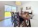 Dining room with a large table, six chairs and sliding glass doors leading to the backyard at 32046 Powderpuff Mimosa Dr, San Antonio, FL 33576