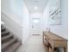 Bright entryway featuring tile floors, a staircase, modern console table, and ample natural light for a welcoming ambiance at 32046 Powderpuff Mimosa Dr, San Antonio, FL 33576